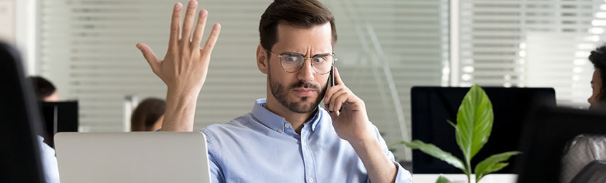 Frustrated businessman on phone