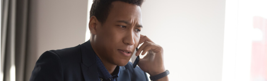 Concerned looking businessman man on a phone call