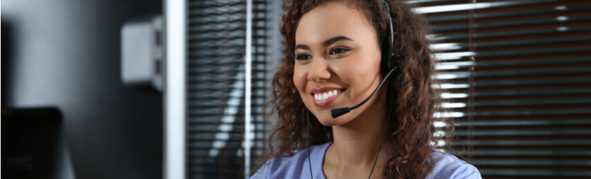 Technical support operator with headset at workplace