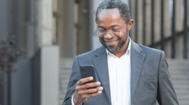 lawyer smiling at cell phone screen